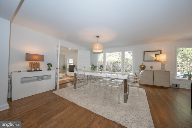 dining room featuring crown molding and dark wood-style flooring