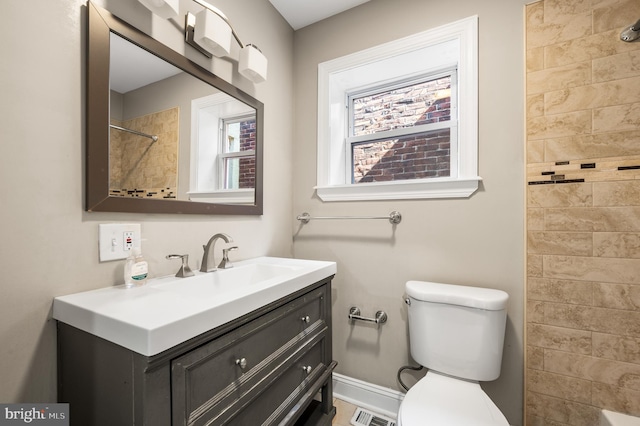 full bathroom featuring vanity, toilet, visible vents, and walk in shower