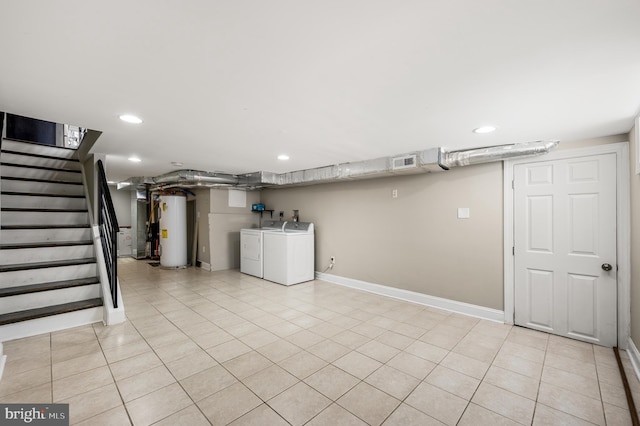 finished basement with stairway, visible vents, recessed lighting, water heater, and washing machine and dryer