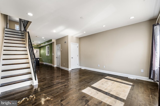 unfurnished living room featuring recessed lighting, baseboards, hardwood / wood-style floors, and stairs