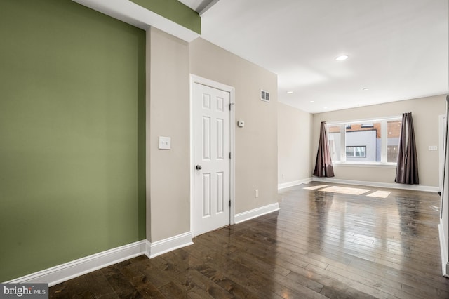 unfurnished room with recessed lighting, visible vents, baseboards, and wood-type flooring