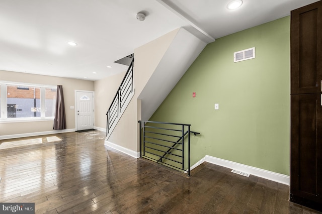 entrance foyer with baseboards, visible vents, and wood-type flooring