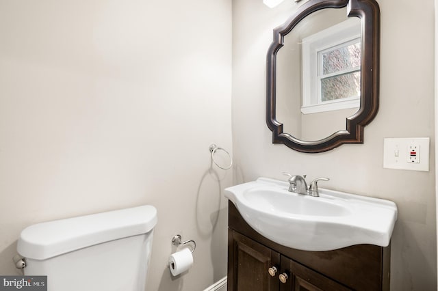 half bathroom featuring toilet and vanity