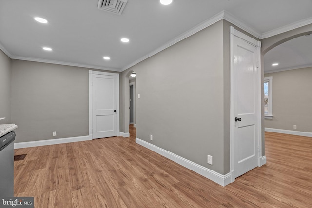 interior space featuring visible vents, arched walkways, light wood-style floors, and crown molding