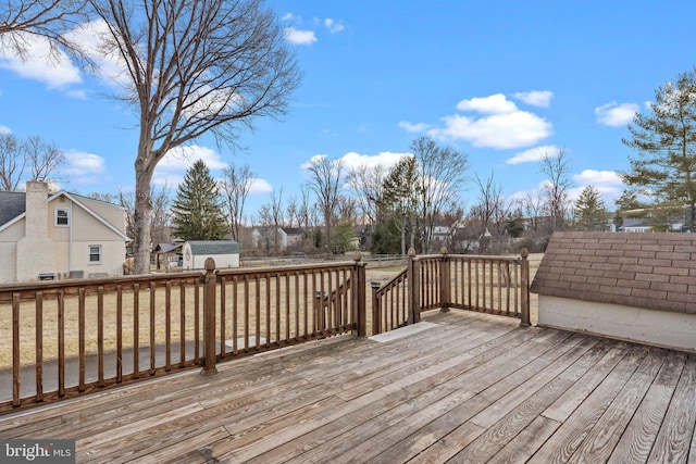 deck with a storage shed and an outdoor structure