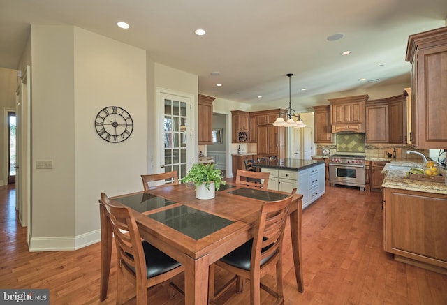 dining room featuring recessed lighting, baseboards, and light wood finished floors