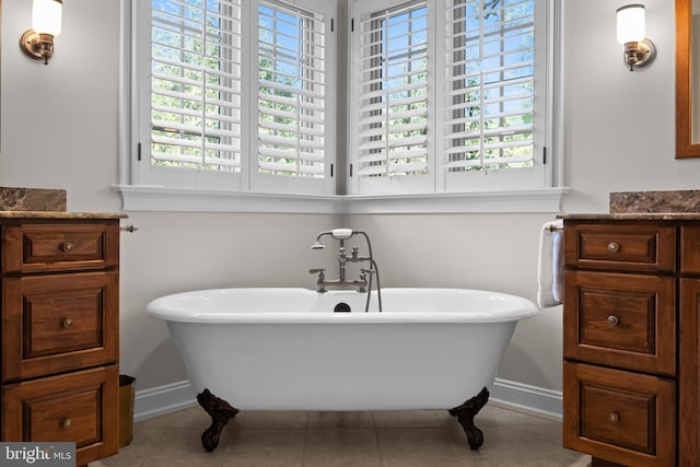 full bathroom featuring tile patterned flooring, plenty of natural light, and a freestanding bath