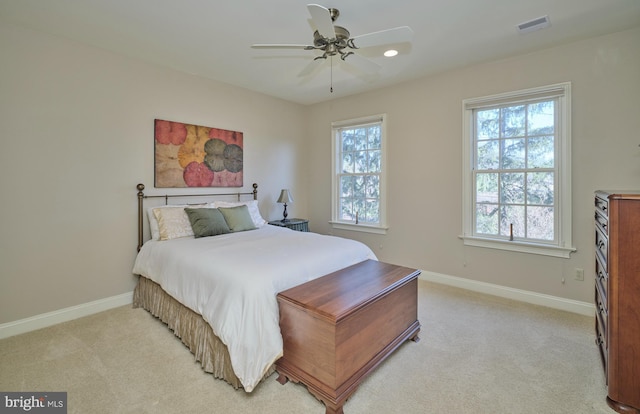 bedroom with visible vents, light colored carpet, and baseboards