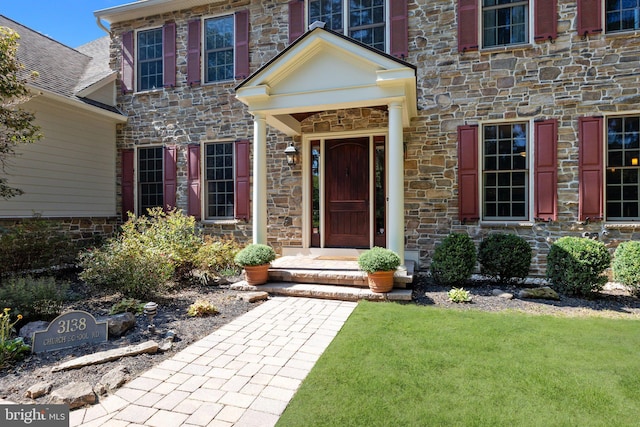 property entrance featuring stone siding