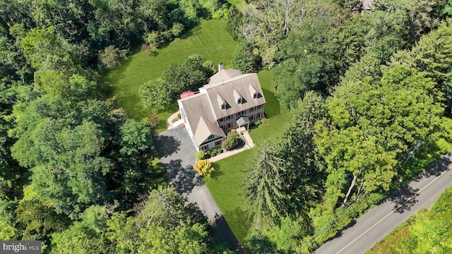 birds eye view of property with a view of trees