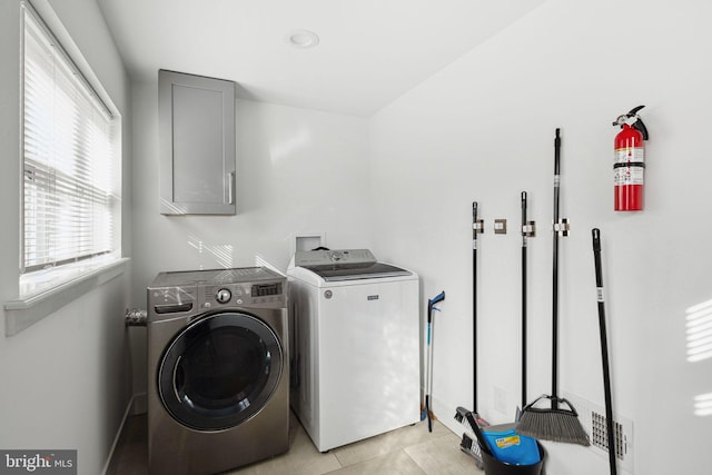 laundry area featuring cabinet space and separate washer and dryer