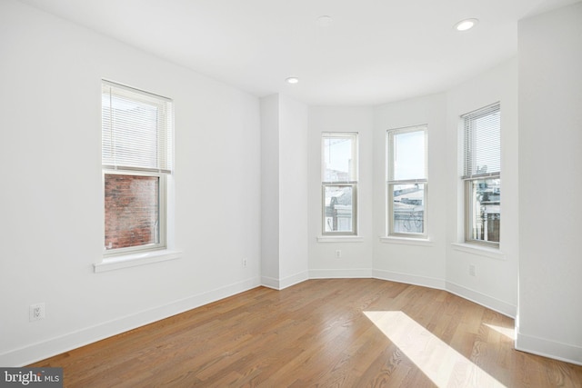 unfurnished room featuring recessed lighting, baseboards, and wood finished floors