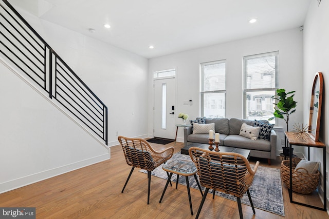 living area featuring recessed lighting, stairs, baseboards, and wood finished floors