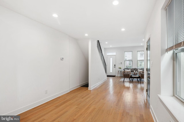 interior space with stairs, recessed lighting, baseboards, and light wood finished floors