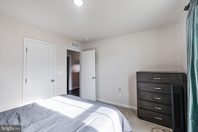 carpeted bedroom with baseboards and visible vents