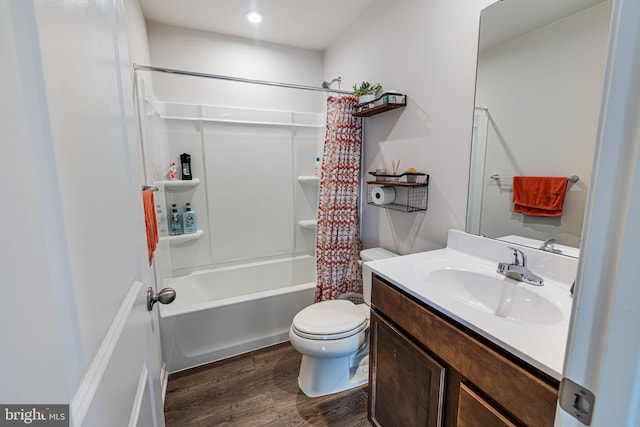 full bath with shower / bath combo with shower curtain, toilet, wood finished floors, and vanity