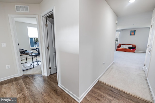 corridor featuring visible vents, recessed lighting, baseboards, and wood finished floors