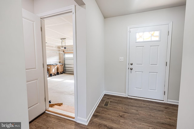 entryway with visible vents, baseboards, and wood finished floors