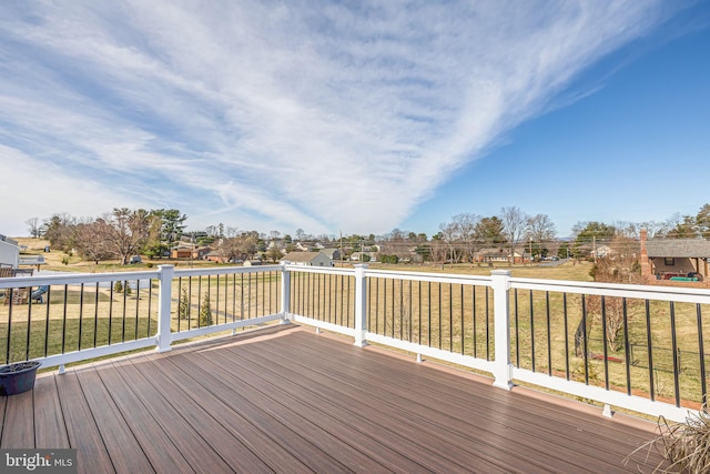 wooden terrace featuring a lawn