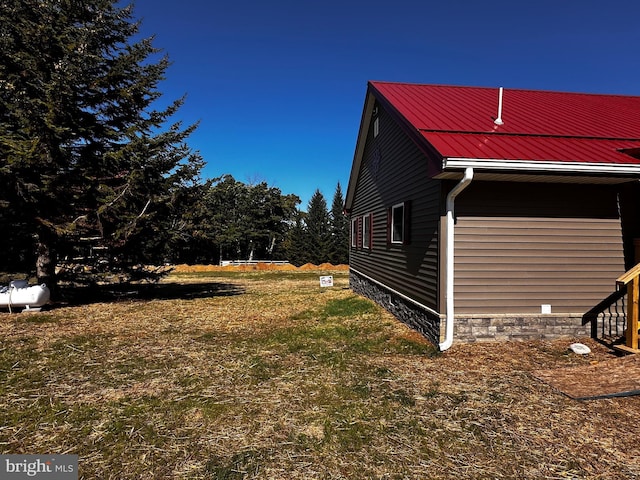 view of side of home with metal roof