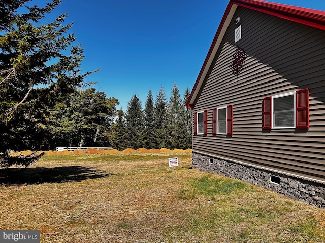 view of home's exterior with crawl space and a lawn