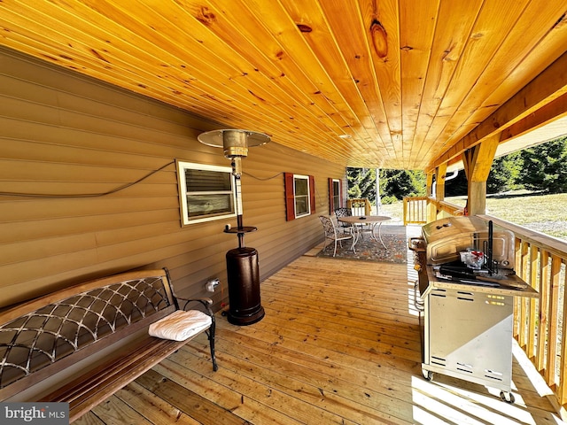 wooden terrace with outdoor dining space