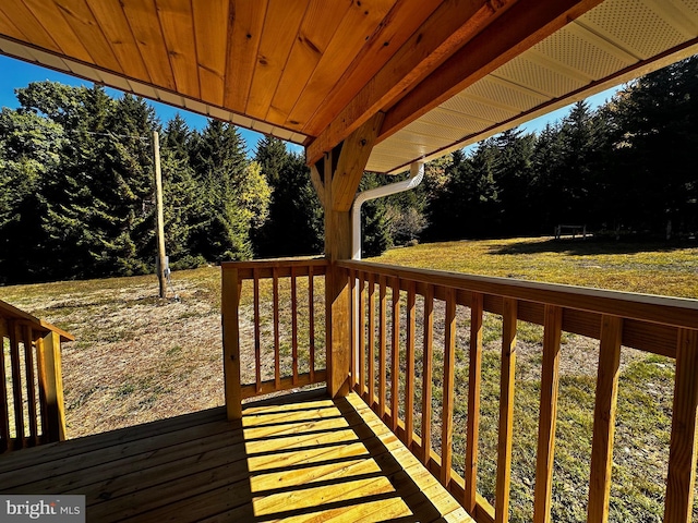 wooden terrace featuring a yard