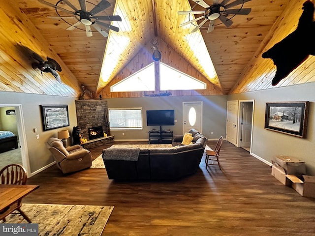 living area featuring a stone fireplace, wood ceiling, wood finished floors, and ceiling fan