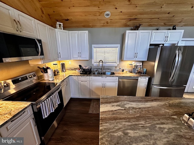 kitchen featuring a sink, stainless steel appliances, light stone counters, and white cabinets