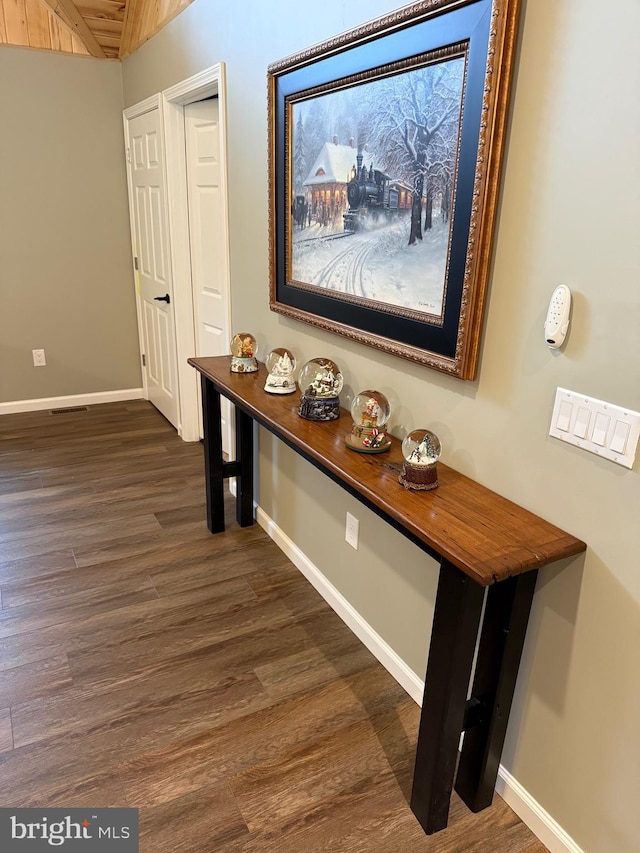 hallway with baseboards and dark wood-style floors