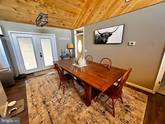 dining area featuring baseboards, lofted ceiling, wooden ceiling, french doors, and wood finished floors