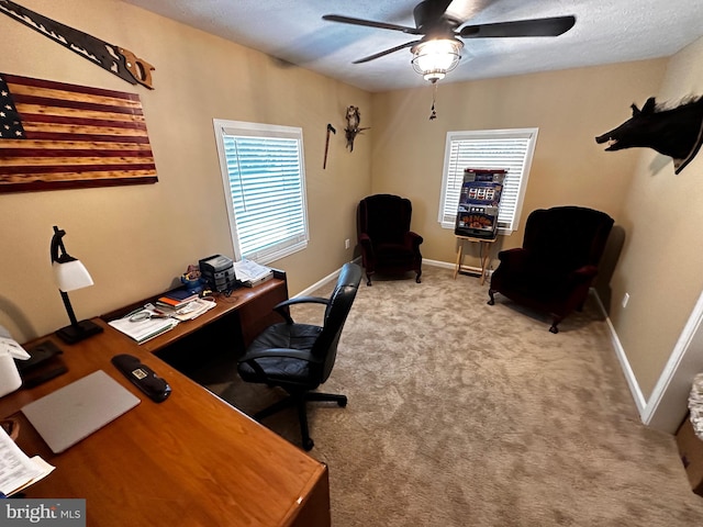 office space featuring baseboards, a textured ceiling, a ceiling fan, and carpet floors