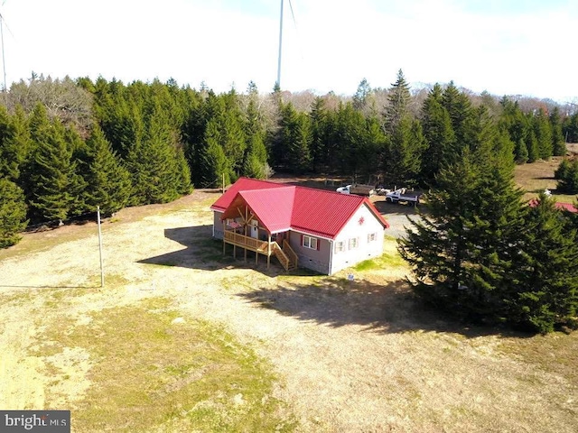 birds eye view of property with a view of trees