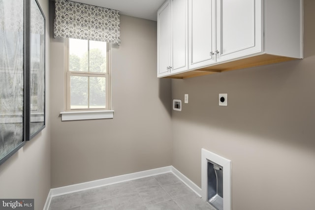 laundry room featuring washer hookup, cabinet space, light tile patterned floors, baseboards, and hookup for an electric dryer