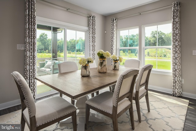 dining area featuring light wood-type flooring and baseboards