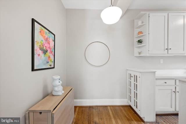 interior space with baseboards and light wood-style floors