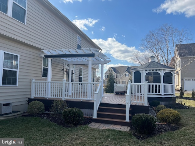 deck with a gazebo, central air condition unit, a lawn, and a pergola