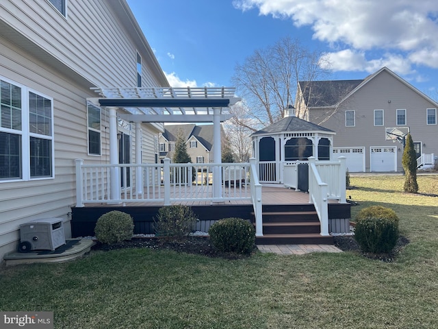 rear view of house with a gazebo, a yard, a pergola, and a wooden deck