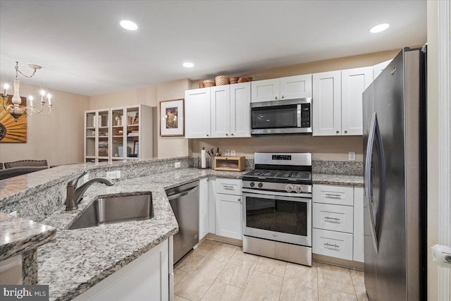 kitchen featuring a sink, white cabinets, and stainless steel appliances