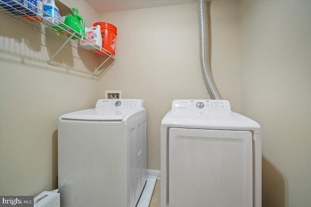 laundry area featuring washing machine and clothes dryer and laundry area