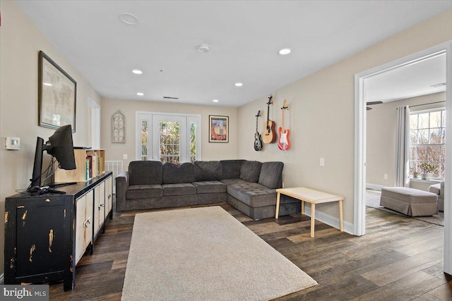 living room with recessed lighting, dark wood-style flooring, and a wealth of natural light