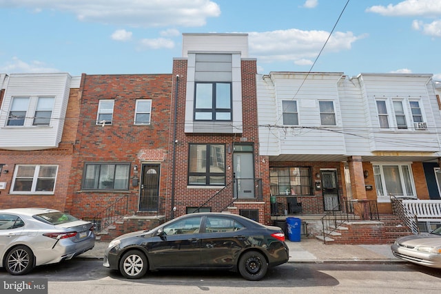 townhome / multi-family property featuring brick siding