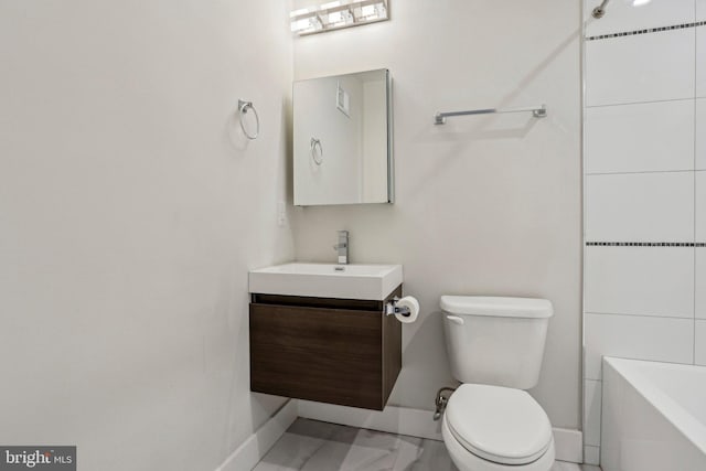 full bath with vanity, toilet, and baseboards