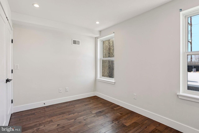 unfurnished room featuring visible vents, recessed lighting, baseboards, and dark wood-style flooring