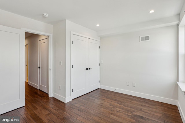 unfurnished bedroom featuring dark wood finished floors, recessed lighting, baseboards, and visible vents