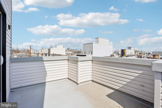 view of patio / terrace with a view of city and a balcony