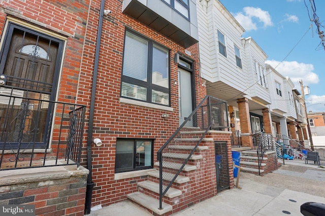 view of side of home with brick siding