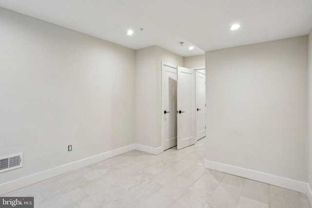 unfurnished room featuring recessed lighting, baseboards, and visible vents