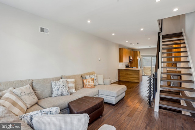 living room featuring visible vents, dark wood-type flooring, baseboards, stairs, and recessed lighting