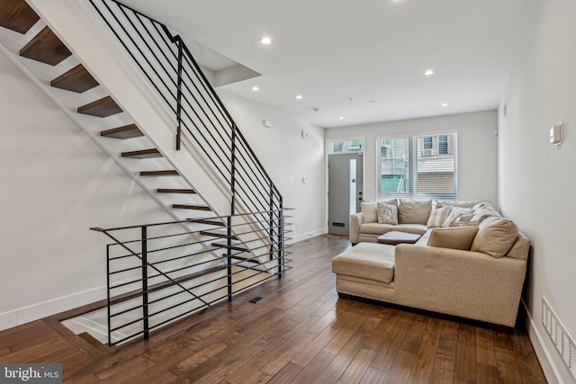 living area featuring visible vents, recessed lighting, stairway, wood-type flooring, and baseboards